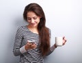 Cute smiling casual woman texting sms on mobile phone and drinking coffee Royalty Free Stock Photo