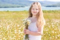 Cute smiling child girl at camomile field Royalty Free Stock Photo