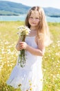 Cute smiling child girl at camomile field Royalty Free Stock Photo