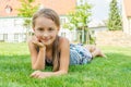 Cute child girl laying in grass in city park Royalty Free Stock Photo