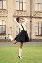 cute smiling confident schoolgirl jumping. sense of freedom. back to school. Cheerful smart schoolgirl. Ending of school