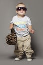 Cute smiling dancing little blond boy in suglasses Royalty Free Stock Photo