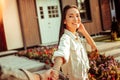 Cute smiling dark-haired girl in white jacket showing white teeth