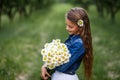 Cute smiling girl with a bouquet of daisies and a flower in the hair. girl with a bunch of chamomiles