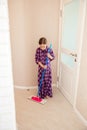 Cute smiling girl cleaning up living room and washing wooden floor