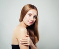 Cute smiling girl portrait. Young woman with healthy hair and clear skin on white background Royalty Free Stock Photo