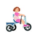 Cute smiling girl riding bicycle. Little kid learning on a first tricycle bike. Flat vector illustration isolated on Royalty Free Stock Photo