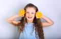 Cute smiling happy kid girl with curly hair style holding citrus Royalty Free Stock Photo