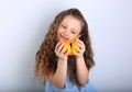 Cute smiling happy kid girl with curly hair style holding and pl Royalty Free Stock Photo