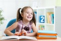 Cute smiling kid reading book in children room Royalty Free Stock Photo