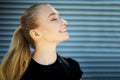 Cute smiling and laughing young blonde woman, exercising in city outdoor, lifestyle portrait. Royalty Free Stock Photo