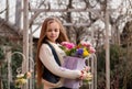Cute smiling little girl with bouquet of spring flowers in hands outdoor Royalty Free Stock Photo