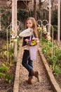 Cute smiling little girl with bouquet of spring flowers in hands outdoor Royalty Free Stock Photo