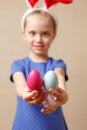 Cute smiling little girl with colorful easter eggs. Happy easter. selective focus