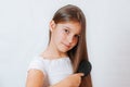 Cute smiling little girl combing her hair comb makes hair Royalty Free Stock Photo