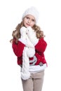 Cute smiling little girl with curly hairstyle wearing knitted sweater, scarf, hat and gloves isolated on white background. Royalty Free Stock Photo