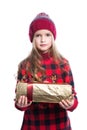 Cute smiling little girl with curly hairstyle wearing knitted sweater, scarf and hat holding christmas gift isolated on white Royalty Free Stock Photo