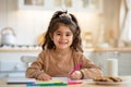 Cute Smiling Little Girl Drawing In Kitchen Interior, Sitting At Table Royalty Free Stock Photo