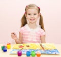 Cute smiling little girl drawing with paint Royalty Free Stock Photo