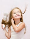 Cute smiling Little girl dries hair