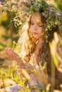 Cute smiling little girl  with flower wreath on the meadow at the farm. Portrait of adorable small kid outdoor Royalty Free Stock Photo