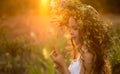 Cute smiling little girl  with flower wreath on the meadow at the farm. Portrait of adorable small kid outdoor Royalty Free Stock Photo