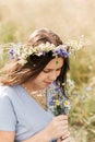 Cute smiling little girl with flower wreath on the meadow. Portrait of adorable small kid outdoors Royalty Free Stock Photo