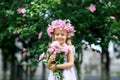 Cute smiling little girl with flower wreath on the park. Portrait of adorable small kid outdoors. Midsummer. Earth Day Royalty Free Stock Photo