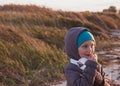 Cute smiling little girl headphones outdoor on beach. Family walking lifestyle Happy kid in earphones listening to music Royalty Free Stock Photo