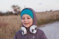 Cute smiling little girl headphones outdoor on beach. Family walking lifestyle Happy kid in earphones listening to music Royalty Free Stock Photo