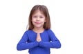 Cute smiling little girl holding prayers hands