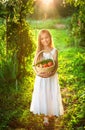 Cute smiling little girl holds basket with fruit and vegetables Royalty Free Stock Photo