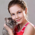 Cute smiling little girl holds funny gray chinchilla. Royalty Free Stock Photo