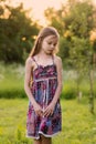 Cute smiling little girl on the meadow at the farm. Portrait of adorable small kid outdoor Royalty Free Stock Photo