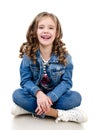 Cute smiling little girl sitting on the floor