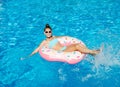 Cute smiling little girl in swimming pool with rubber ring. Child having fun on vacation Royalty Free Stock Photo