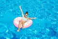 Cute smiling little girl in swimming pool with rubber ring. Child having fun on vacation Royalty Free Stock Photo