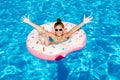 Cute smiling little girl in swimming pool with rubber ring