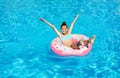 Cute smiling little girl in swimming pool with rubber ring Royalty Free Stock Photo