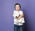 Cute smiling little kid boy in green hat holding hugging his best friend polar bear toy. International day of polar bear concept Royalty Free Stock Photo