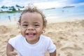 Cute smiling mixed race little boy playing at the beach Royalty Free Stock Photo