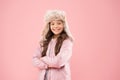 Cute smiling model. Adorable small child wear winter knitted accessory. Cute little girl fashion hat pink background Royalty Free Stock Photo