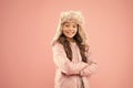 Cute smiling model. Adorable small child wear winter knitted accessory. Cute little girl fashion hat pink background Royalty Free Stock Photo