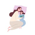 Cute smiling mother and daughter in pyjamas lying in bed and reading book or fairytale. Happy adorable mom and child Royalty Free Stock Photo