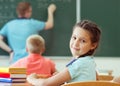 Cute smiling schoolgirl at school