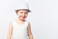 Cute smiling summer boy in white shirt and hat on white background. Shirt mockup, summer child fashion Royalty Free Stock Photo