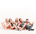 cute smiling tenagers sitting on the floor Royalty Free Stock Photo