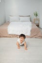 Cute smiling toddler baby girl crawling on the floor Royalty Free Stock Photo