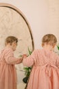 cute smiling toddler girl near mirror