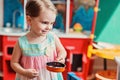 Cute smiling toddler girl playing with toy kitchen at home Royalty Free Stock Photo